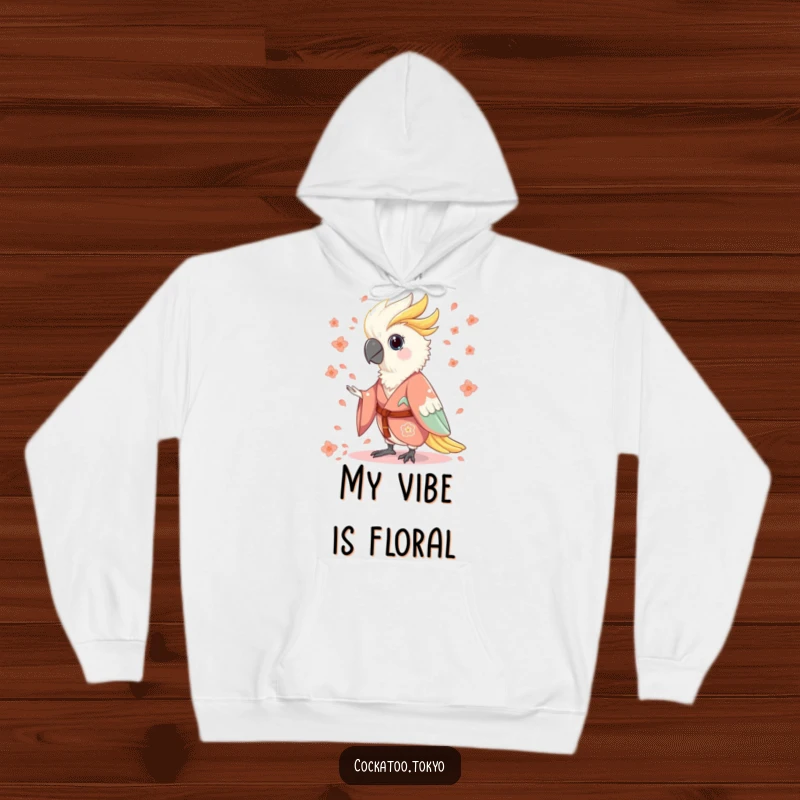 Funny Hoodie featuring a charming cockatoo in a flowing kimono, humorously scattering flower petals, offering warmth and whimsical style.